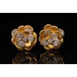 A pair of Kutchinsky platinum and 18ct yellow gold diamond earrings, each comprises a flower head