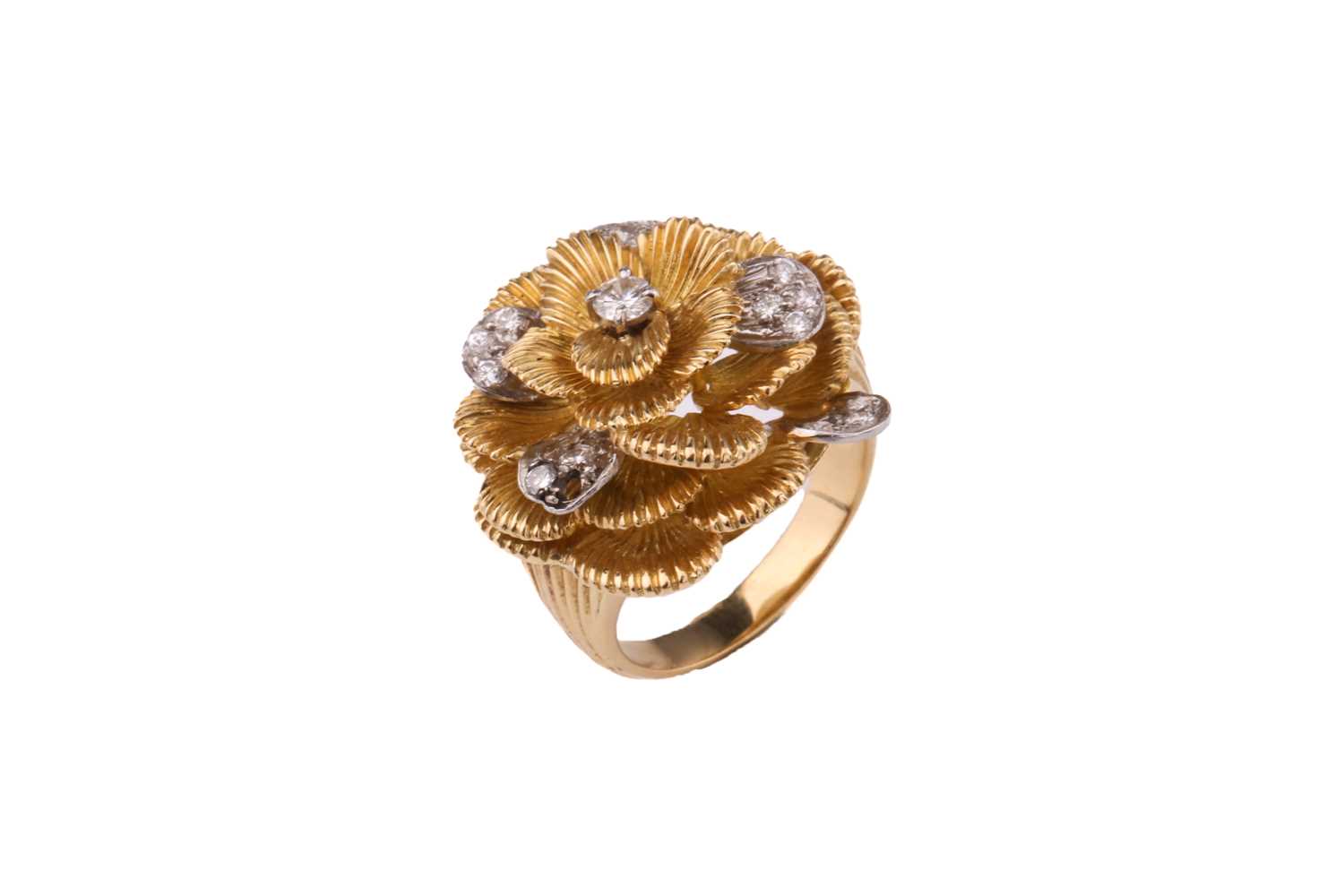 A Kutchinsky platinum and 18ct yellow gold diamond ring, comprises a flower head with layering