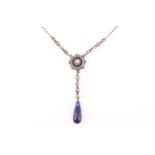 A silver drop necklace with blue and white stones, consisting of a target pendant and a sodalite
