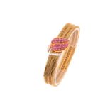 A Kutchinsky ruby and diamond slide bracelet, comprises an 18ct yellow gold woven link terminates