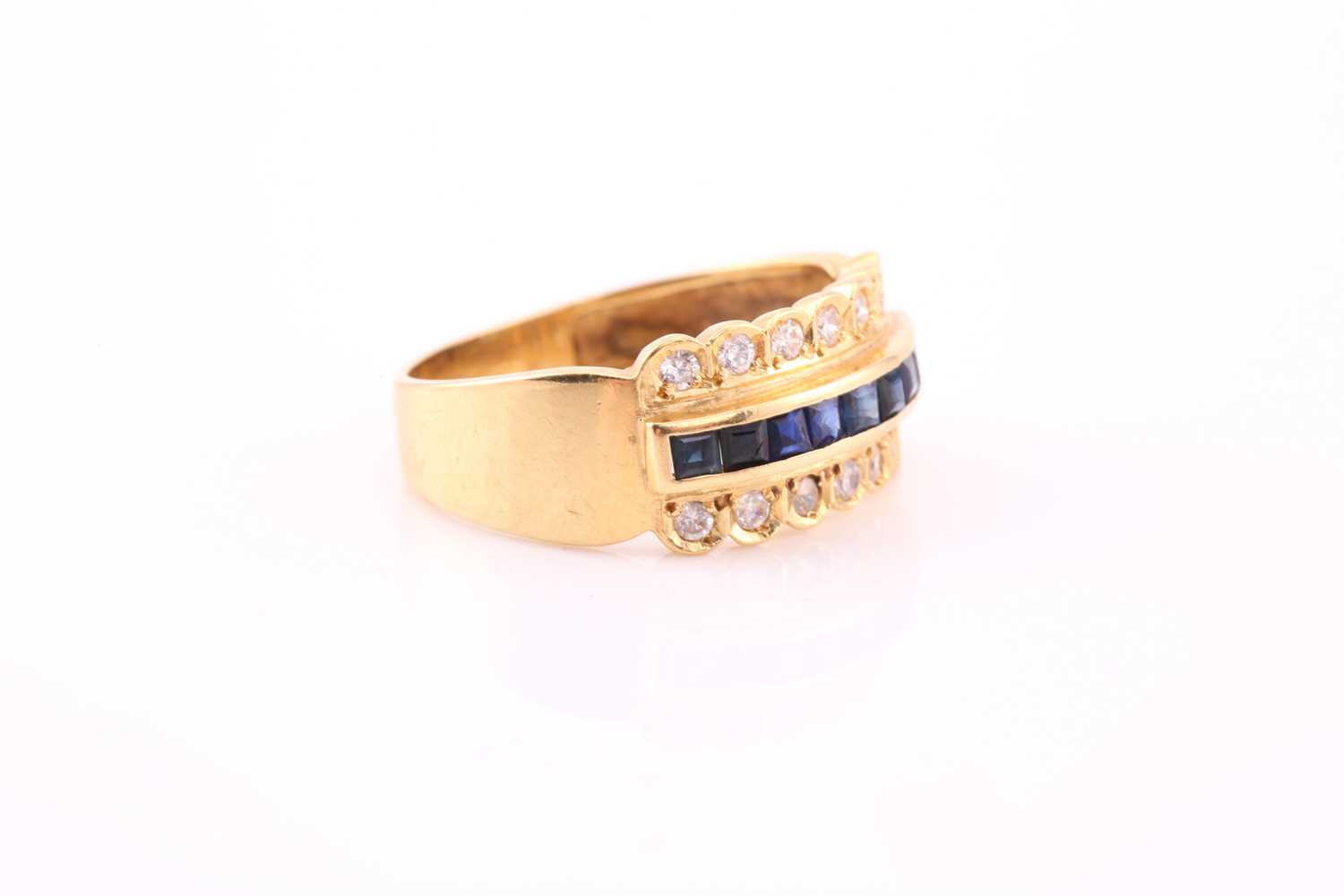 A yellow metal, diamond, and sapphire ring, channel-set to centre with a row of calibre-cut