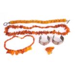 A lot consists of three amber bead necklaces, an amber brooch and a pair of Turkman metal cuff