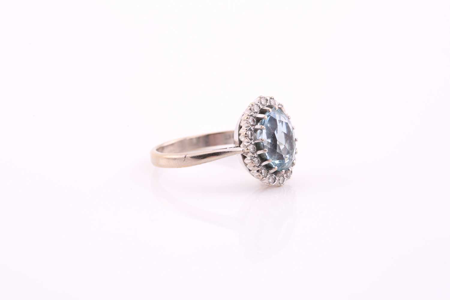 An aquamarine and diamond cluster ring, the oval mixed cut aquamarine 10.2mm x 8mm, surrounded by - Image 4 of 4