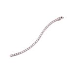 A diamond tennis bracelet, set with thirty-three round brilliant diamonds, each weighing an