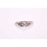 A diamond cathedral engagement ring, consisting of a round brilliant central diamond of 0.37cts,