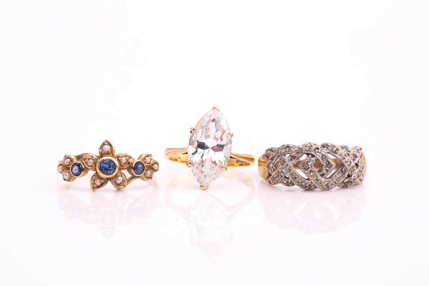 A lot consists of three rings, one comprises a marquise cubic zirconia, claw set on an 18ct yellow
