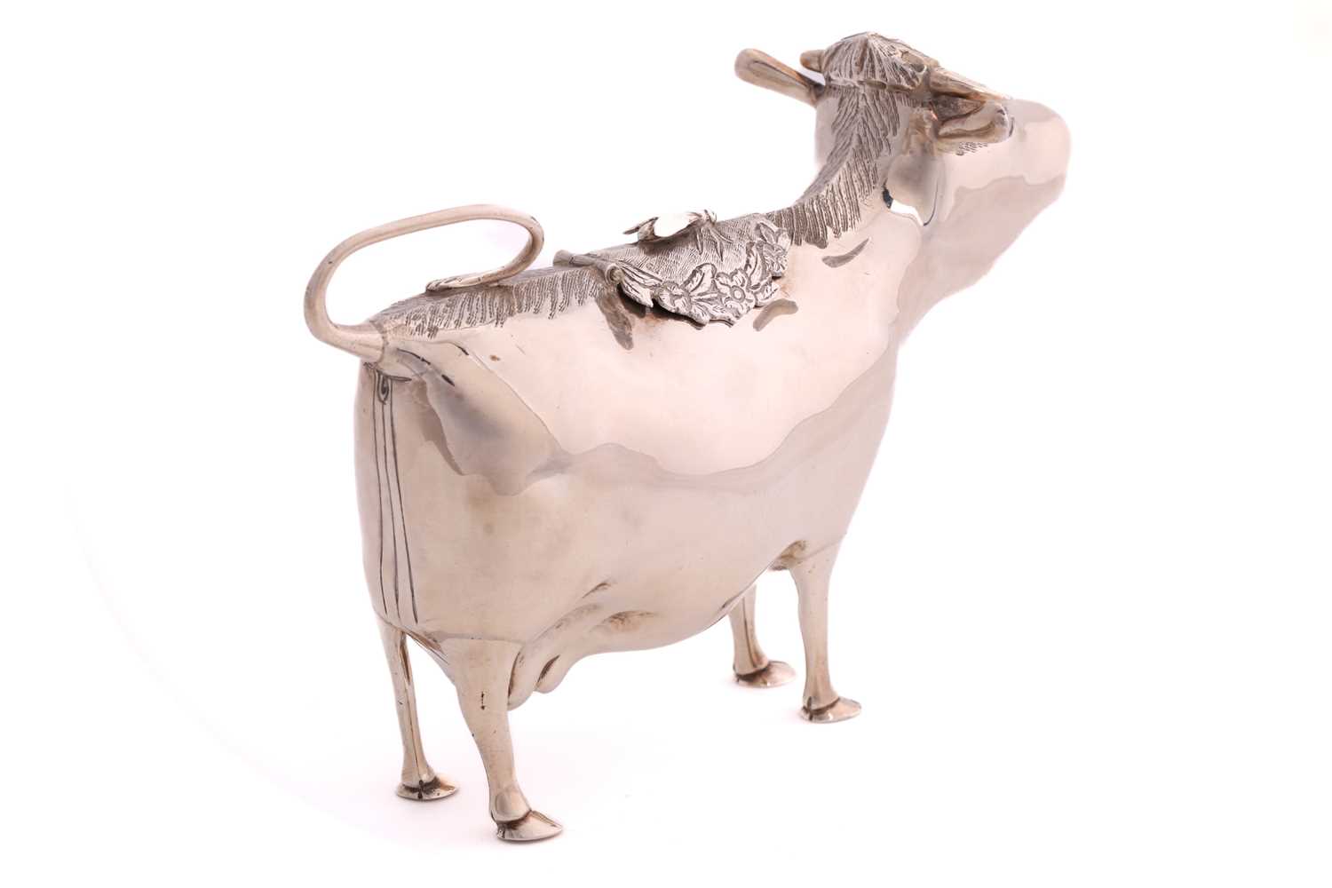 A 20th century silver cow creamer; of traditional form, the hinged cover with an applied bee. London - Image 2 of 4