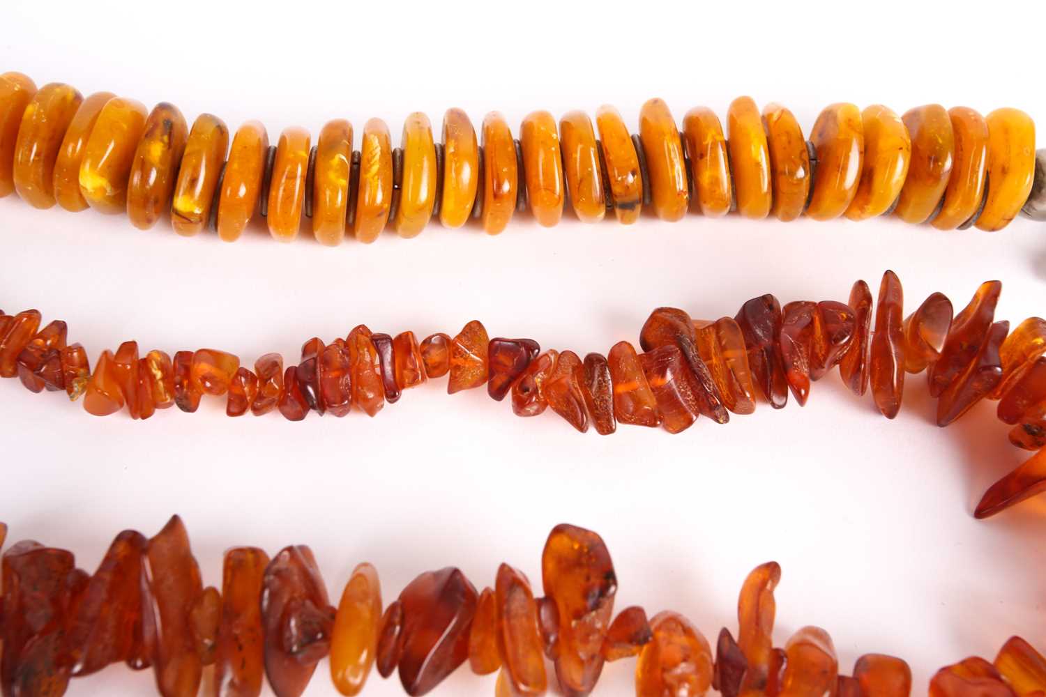 A lot consists of three amber bead necklaces, an amber brooch and a pair of Turkman metal cuff - Image 3 of 5