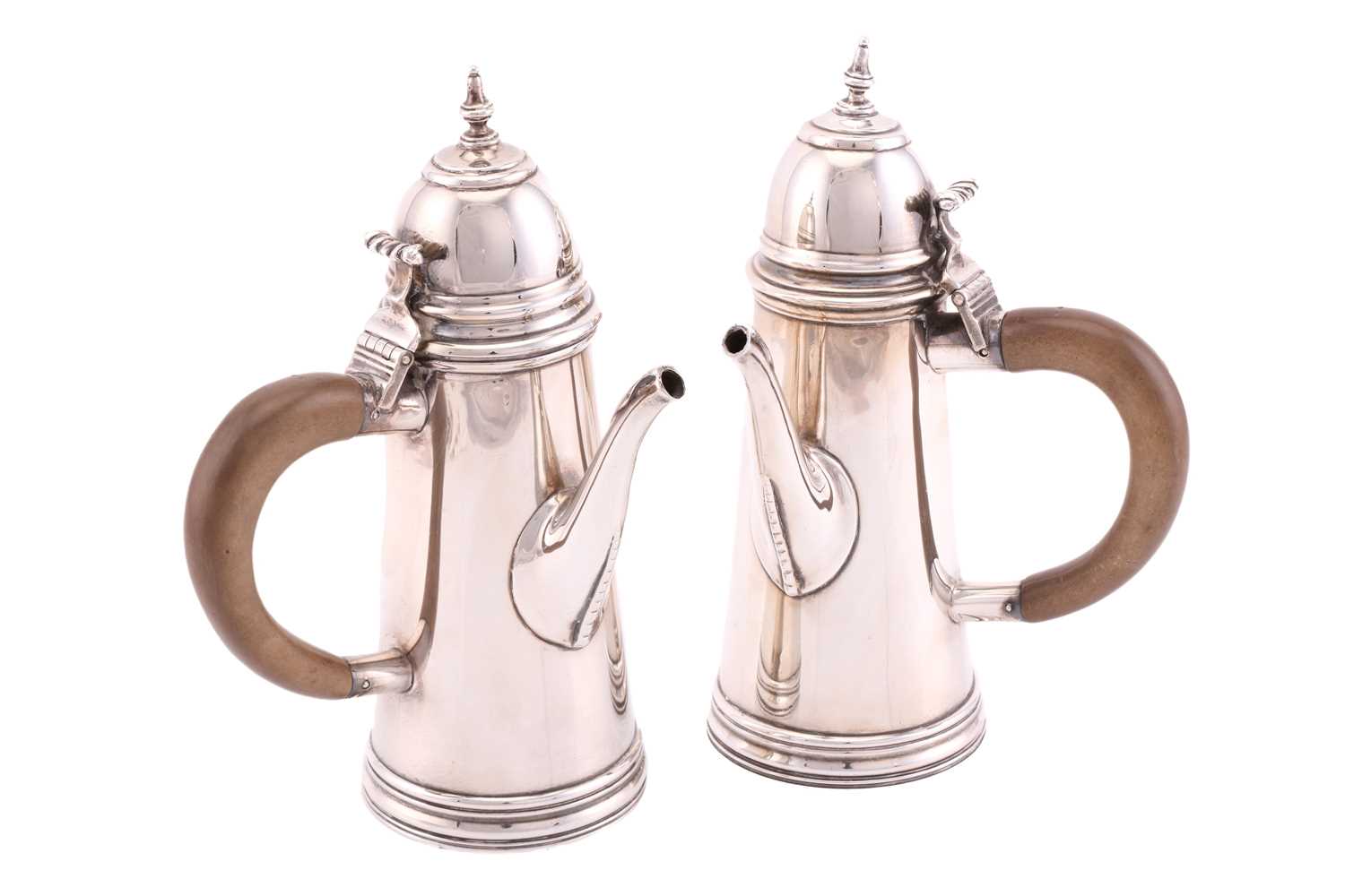 A pair of Queen Anne style silver cafe aut lait pots, London 1910 by William Comyns. Each with