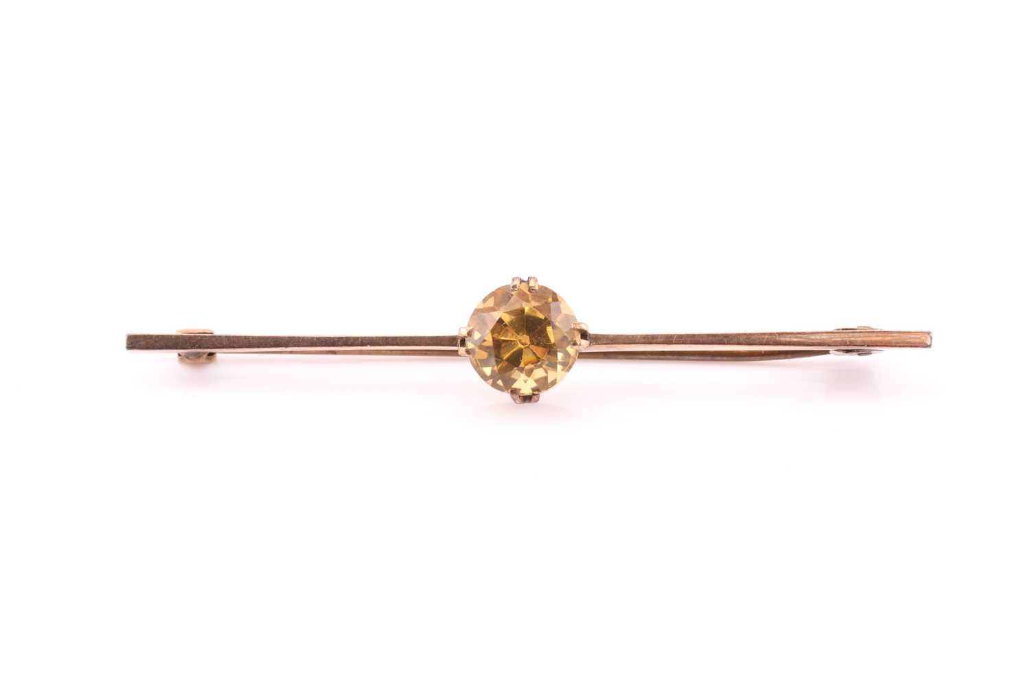 A yellow metal and citrine bar brooch, set with a mixed round-cut stone, approximately 8.7 mm