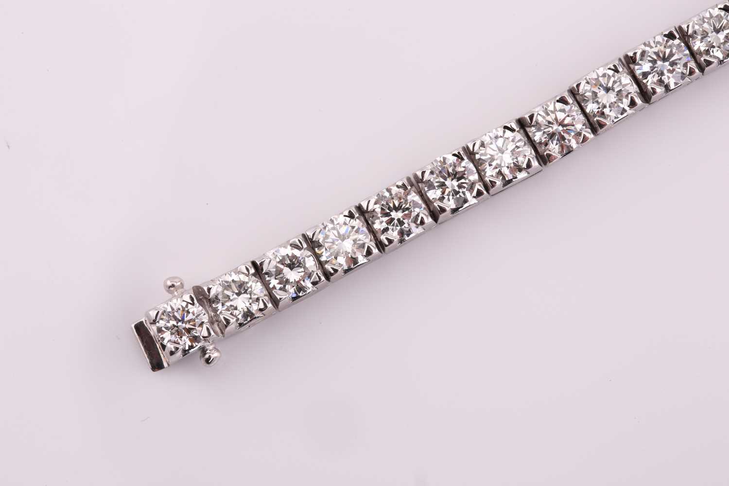 A diamond tennis bracelet, set with thirty-three round brilliant diamonds, each weighing an - Image 4 of 10