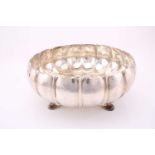 Omar Ramsden. A large Arts and Crafts silver bowl; London 1934; the circular melon fluted, spot