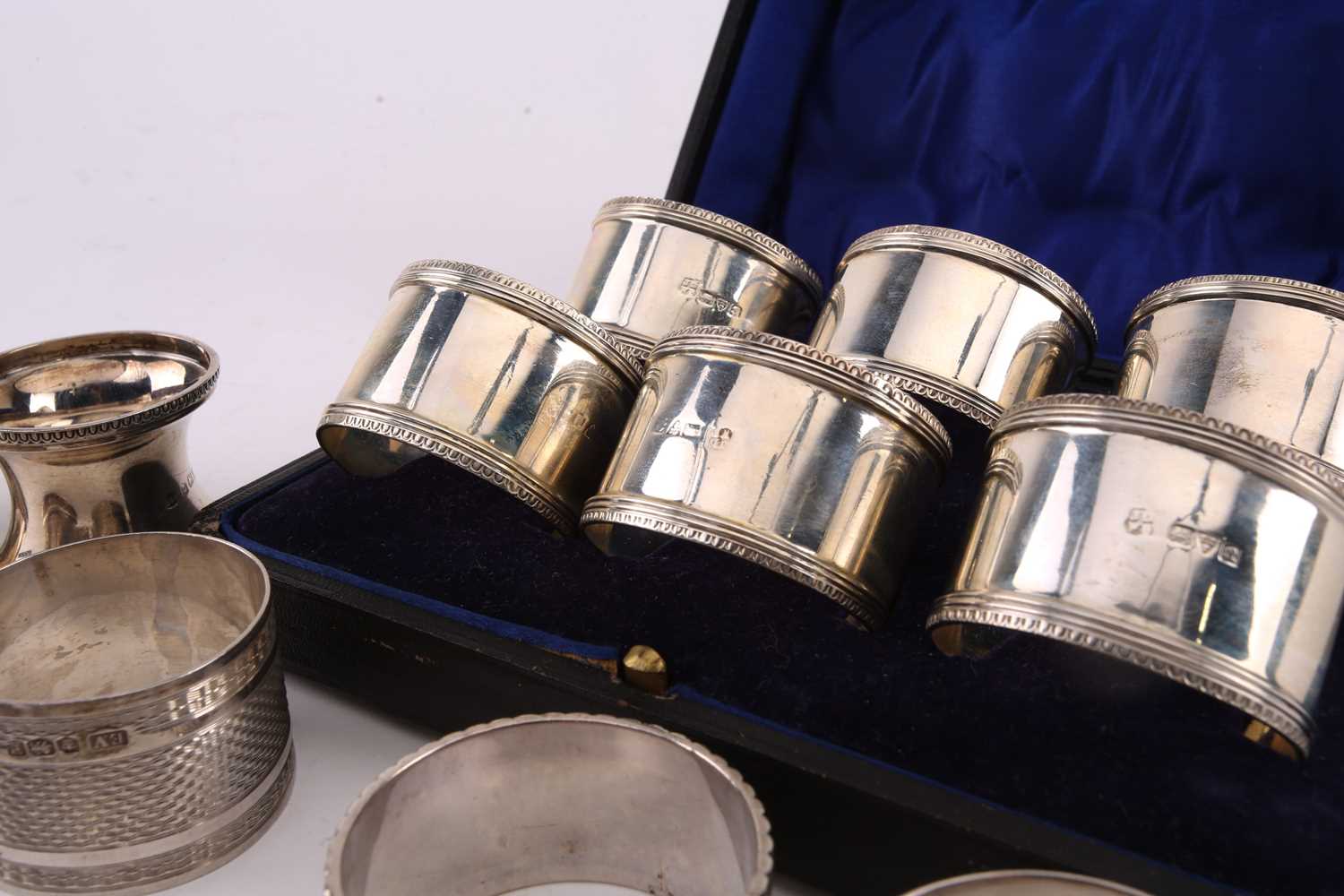 A cased set of six early 20th-century silver napkin rings, Chester 1917 by John & William Deakin. - Image 3 of 3