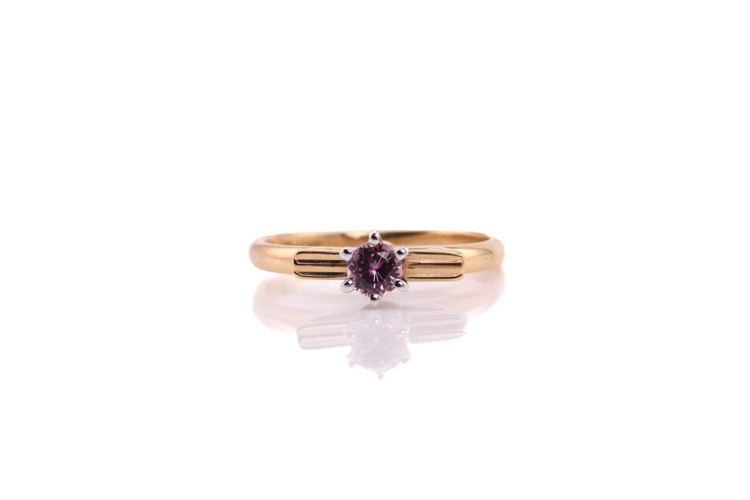 A pink sapphire solitaire ring, comprises a round pale pink sapphire approximately measuring 3.8 mm,