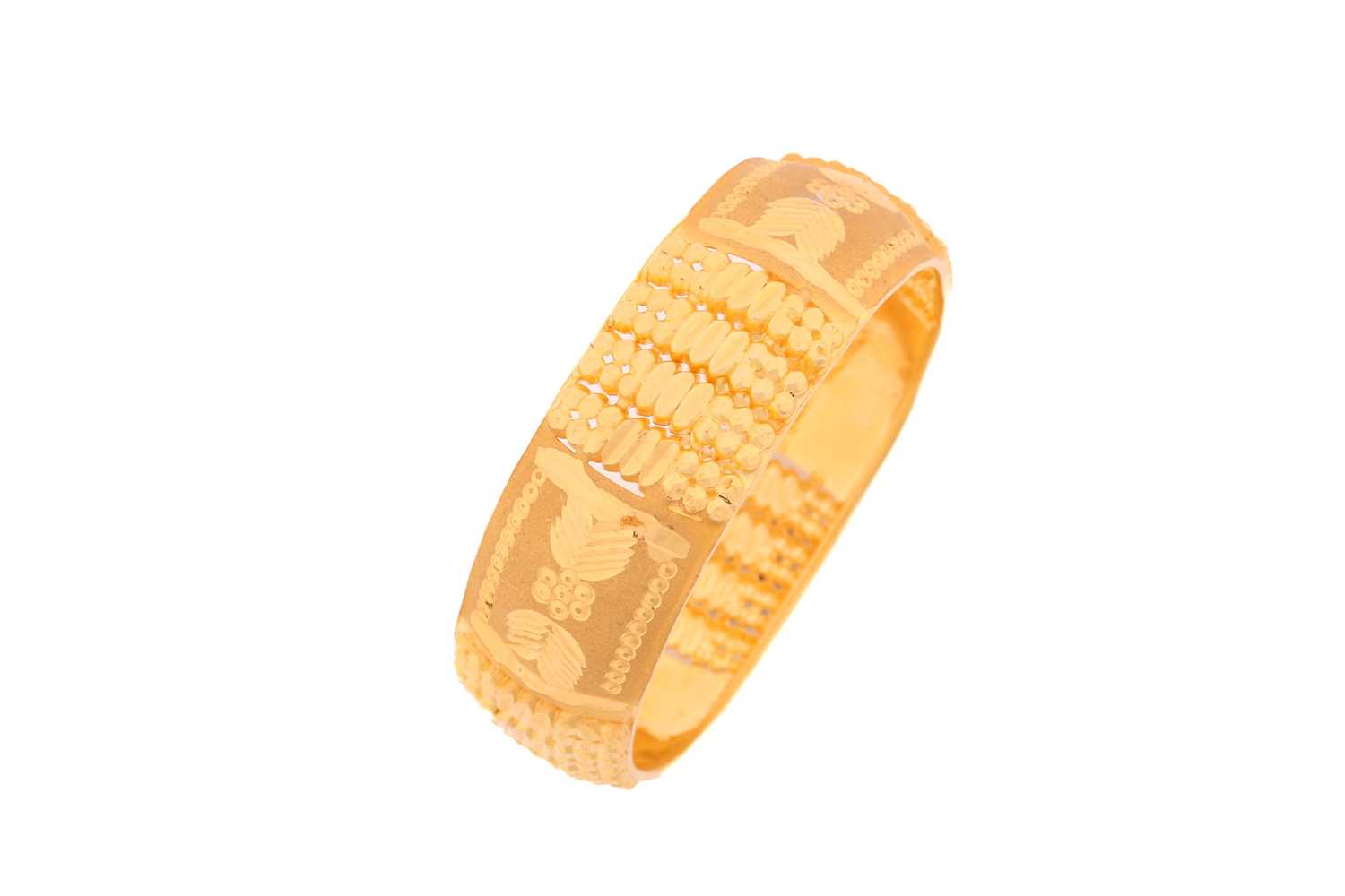 A yellow metal bangle, decorated with pierced, engraved and burred patterns, as well as sandblast - Image 2 of 3