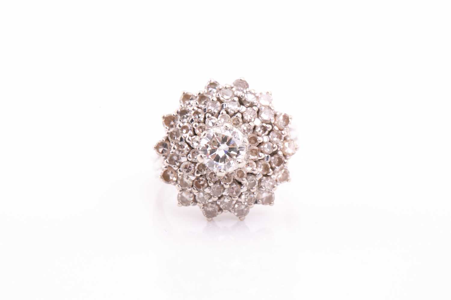 A diamond cluster dress ring; the four tiers of round brilliant cut diamonds in claw mounts and