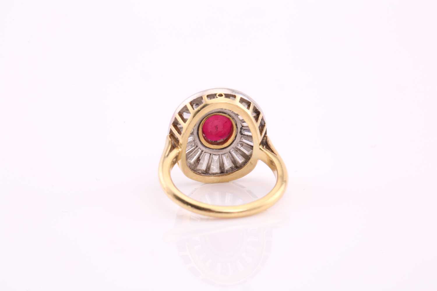 A ruby and diamond cluster ring; the central oval cut ruby in rub over mount within a surround of - Image 7 of 7