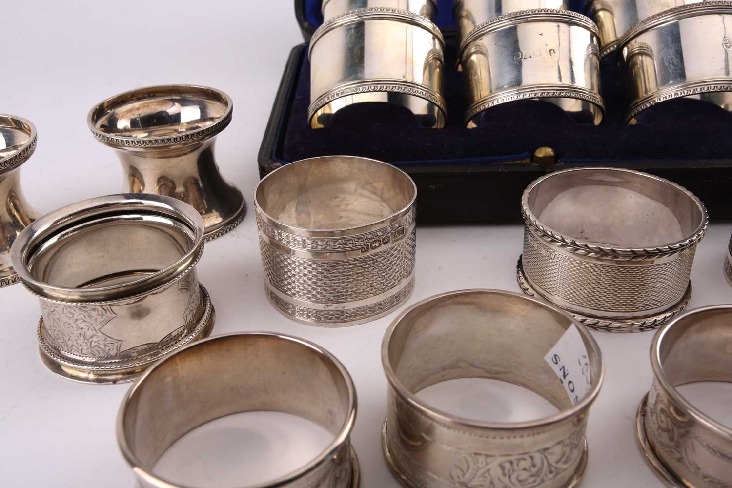 A cased set of six early 20th-century silver napkin rings, Chester 1917 by John & William Deakin. - Image 2 of 3