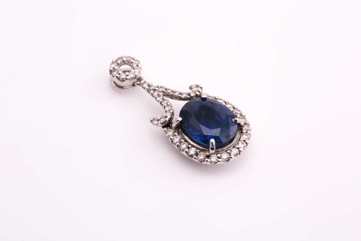 A sapphire and diamond pendant, consisting of an oval sapphire with deep blue body colour and - Image 3 of 3