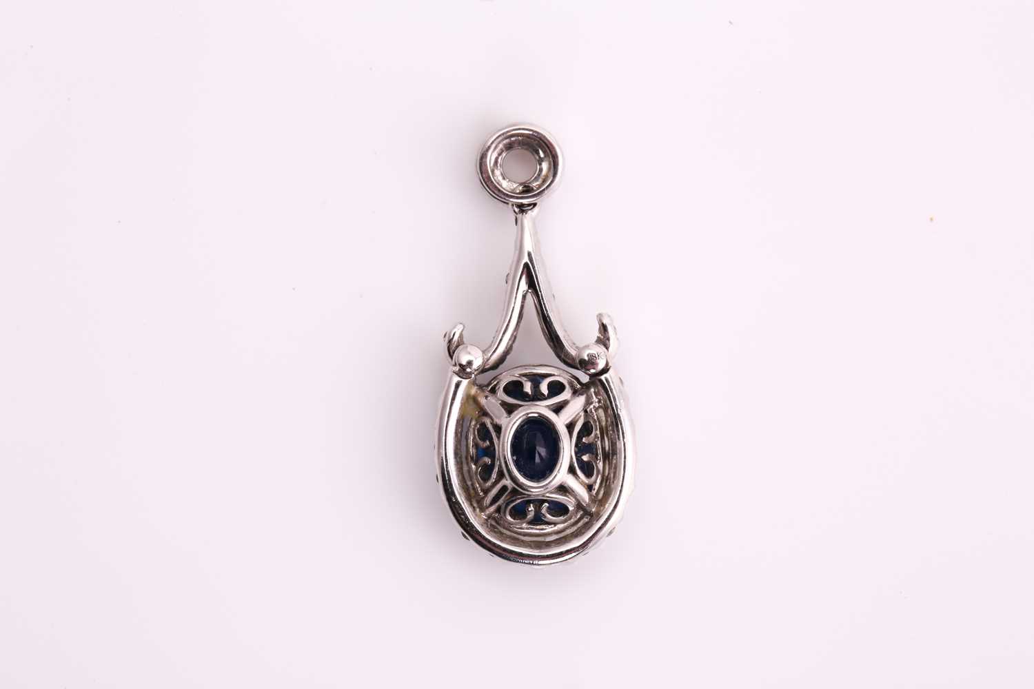 A sapphire and diamond pendant, consisting of an oval sapphire with deep blue body colour and - Image 2 of 3