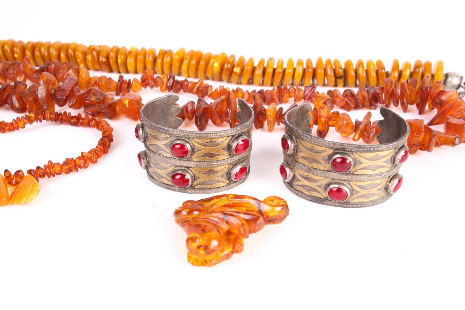 A lot consists of three amber bead necklaces, an amber brooch and a pair of Turkman metal cuff - Image 2 of 5