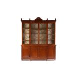 A fine quality 19th-century tulipwood banded figured satinwood breakfront library bookcase in the