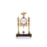 A Lefevre sue de Belle á Paris Empire style portico gilt metal mantle clock, with white enamel dial,