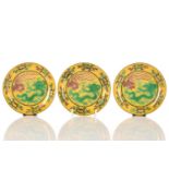A set of three Chinese porcelain dragon and Fenghuang dishes, the incised decoration in green and