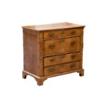 An early 18th-century regional walnut chest of four long drawers, with broad crossbanded and