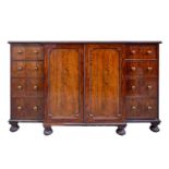 A William IV mahogany breakfront housekeeper's cupboard, in the manner of Gillows.With split