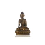 A Chinese Sino Tibetan style gilt bronze figure of Buddha, seated in bhumisparsha mudra, the hair in