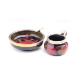Two Moorcroft Pomegranate pattern ashtrays, each with plated mounts, the largest 13 cm diameter.Qty:
