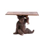 A 20th-century "Black Forest" bear side table with a rectangular top carved with oak leaf decoration