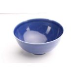 A Chinese blue glazed deep sided bowl, the rounded body with blue glaze throughout fading to white