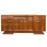 A Continental Art Deco walnut sideboard with raised marble top with central recessed cupboards