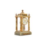 A French onyx and brass four-glass mantel clock, the circular painted enamel dial bearing Arabic