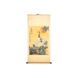 A Chinese scroll painting of two Manchurian cranes, standing on a rock before a pine tree and