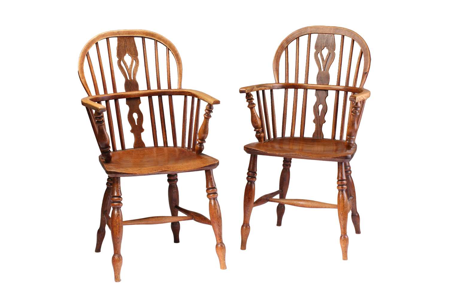 A close pair of 19th-century elm and ash hoop backed Windsor open armchairs with pierced "