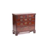 A small George II mahogany bachelor's chest with tooled pigskin lined fold-over top above lopers and