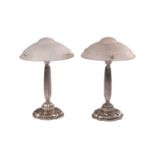 A pair of Art Deco style table lamps with domed frosted glass shades over brushed steel bases with