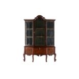 An 18th-century style walnut miniature library bookcase with arched cornicing above a single central