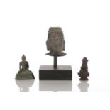 A Chinese bronze bust of Buddha, a small bronze Sino Tibetan figure of Buddha seated in