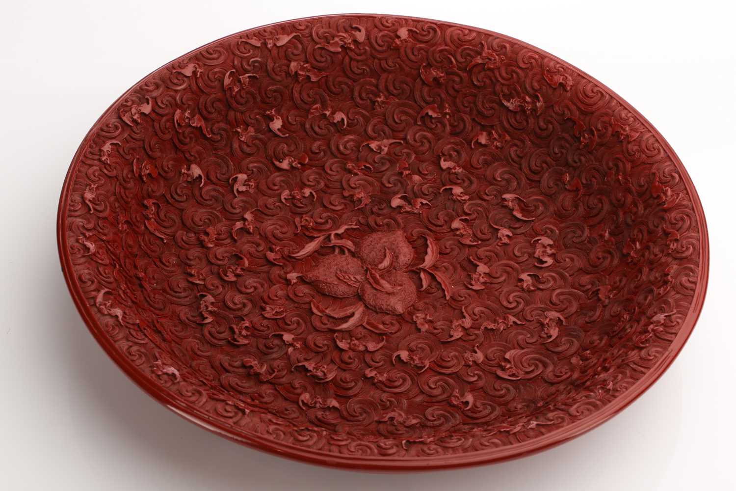 A Chinese cinnabar lacquer dished bowl, 20th century, decorated with three peaches to the centre - Image 7 of 20