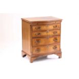A George III style reproduction serpentine canteen chest of drawers containing an incomplete canteen