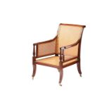 A Regency mahogany Bergere library armchair with scroll back and channelled frame and cluster column