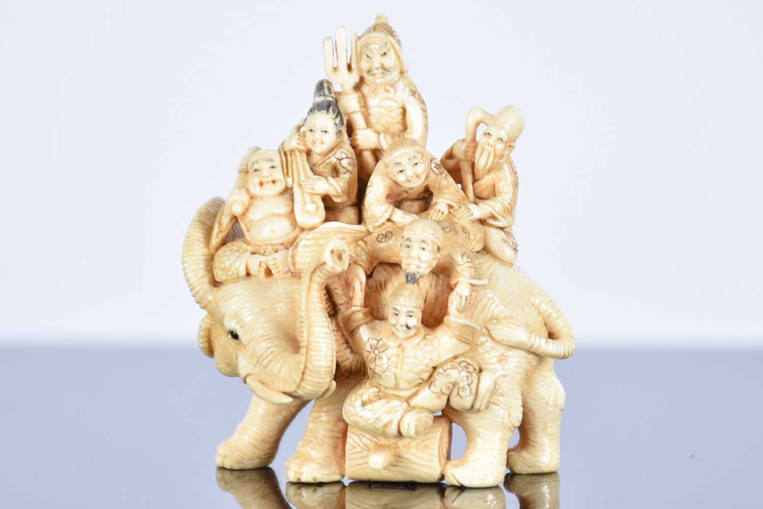 Three Japanese ivory netsukes, Meiji period, comprising the seven gods of good fortune upon an - Image 9 of 11