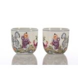 A pair of Chinese porcelain chicken cups, each painted with a young boy and a chicken between