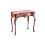 An Irish George II mahogany fold-over gaming table with "penny round" corners. The top opening