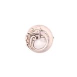 Georg Jensen - A circular fish brooch, depicting a fish coiled in waves, with hinged pin stem and