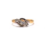 A four-stone diamond bypass ring in 18ct gold, consisting of four brilliant diamonds in graduated